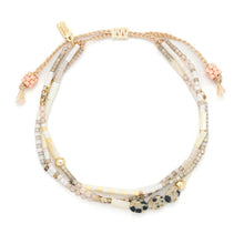 Load image into Gallery viewer, Multistrand beaded bracelet with gold accents on a white background