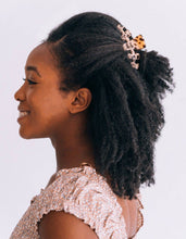 Load image into Gallery viewer, Woman with styled hair featuring a decorative hair clip on a plain background