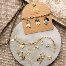 Load image into Gallery viewer, Scout interchangeable charm jewelry set on a marble surface with a beige card.