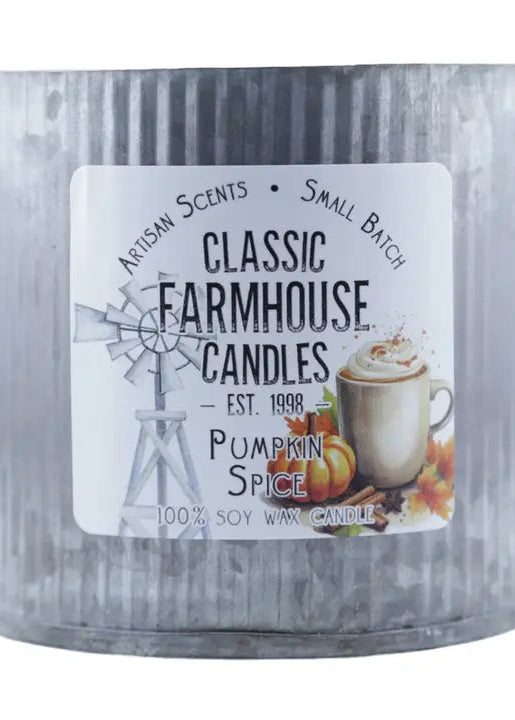 A galvanized metal tin candle with a white label reading 'Classic Farmhouse Candles' and 'Pumpkin Spice'. The label features a windmill illustration and an image of a pumpkin spice latte, set against a plain white background.