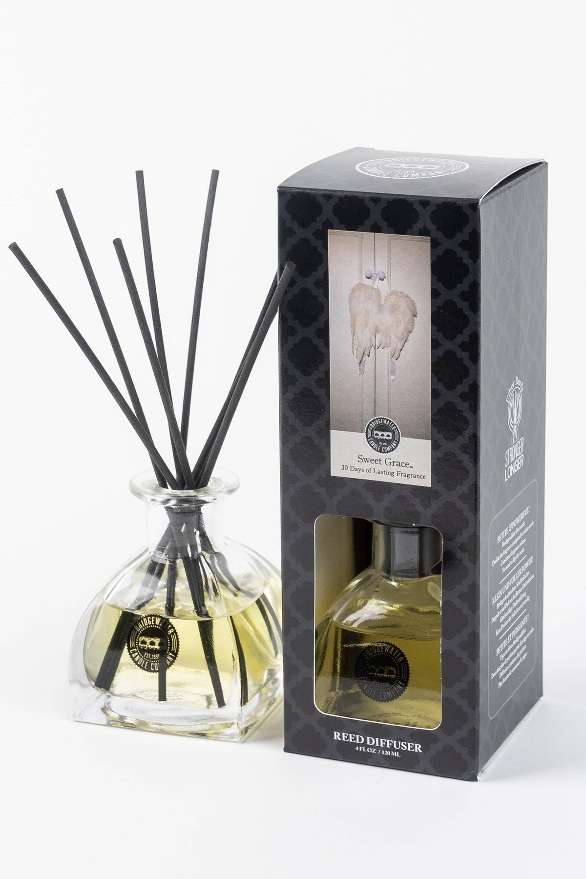 Reed diffuser with packaging on a white background