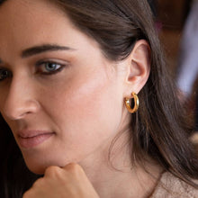 Load image into Gallery viewer, Close-up of a woman wearing gold hoop earrings.