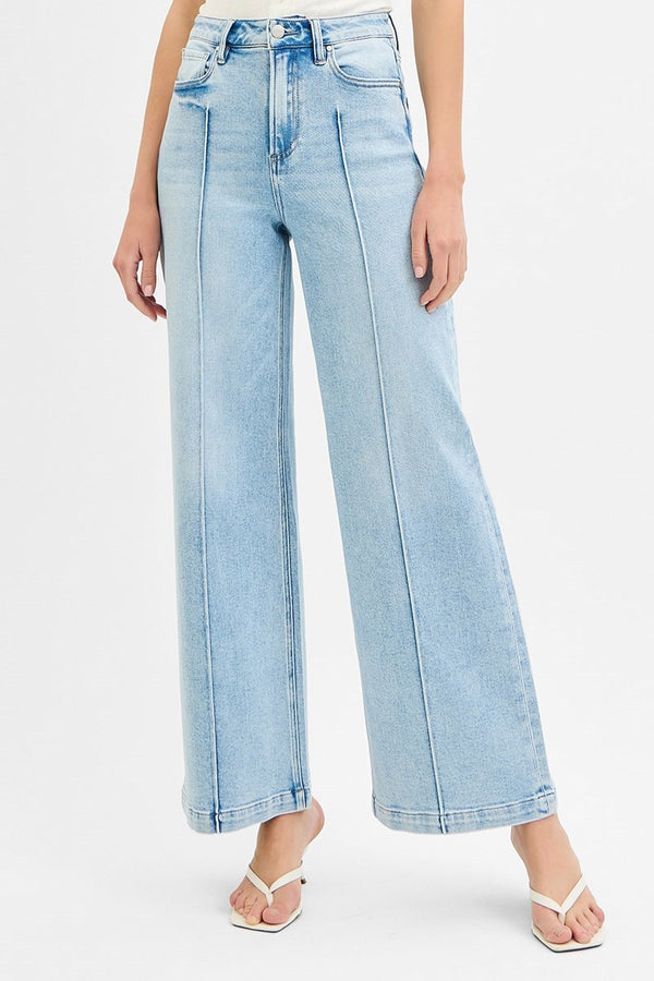Light blue jeans worn by a person on a white background
