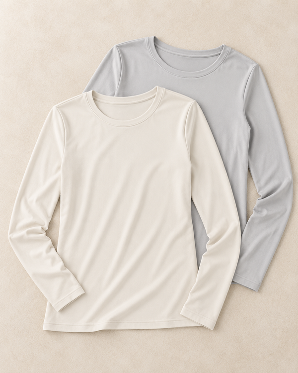 two long sleeve tops laying on professional floor setting, one in ivory color one in light grey