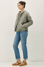 Load image into Gallery viewer, Woman wearing a gray quilted jacket and blue jeans on a white background