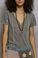 Load image into Gallery viewer, Woman wearing a gray striped shirt with a patchwork skirt against a gray background