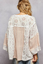 Load image into Gallery viewer, Woman wearing a floral lace top with a gray background