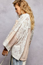 Load image into Gallery viewer, Woman wearing a floral lace kimono against a gray background