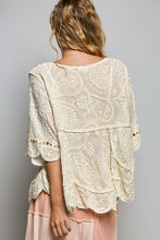 Load image into Gallery viewer, Woman wearing a beige lace top with a gray background