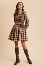 Load image into Gallery viewer, Woman wearing a plaid dress with long sleeves on a beige background