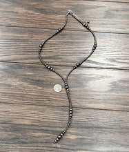 Load image into Gallery viewer, Beaded necklace on a wooden surface with a coin for scale