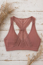Load image into Gallery viewer, Pink lace bralette on a rustic wooden surface with dried flowers.