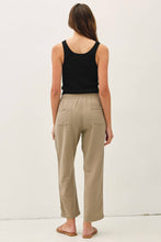 Load image into Gallery viewer, Woman wearing beige pants and a black tank top on a white background
