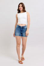 Load image into Gallery viewer, Woman wearing a white sleeveless top and denim shorts on a plain background