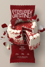 Load image into Gallery viewer, Red velvet protein bar packaging with a cake design on a gray background