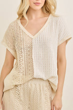 Load image into Gallery viewer, Woman wearing a beige and white outfit with a textured pattern on a plain background