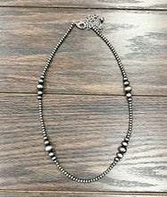 Load image into Gallery viewer, Silver beaded necklace on a wooden surface