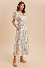 Load image into Gallery viewer, Woman wearing a floral dress on a beige background