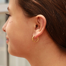 Load image into Gallery viewer, Close-up of a person wearing a gold hoop earring.