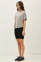 Load image into Gallery viewer, Woman wearing a gray top and black shorts on a white background