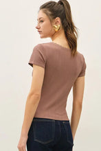 Load image into Gallery viewer, Woman wearing a brown top and dark blue flared jeans on a white background