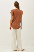 Load image into Gallery viewer, Woman wearing a brown top and white pants on a white background
