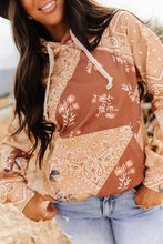 Load image into Gallery viewer, Woman wearing a patterned blouse with floral designs outdoors