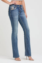 Load image into Gallery viewer, Blue jeans with decorative elements on a white background