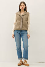 Load image into Gallery viewer, Woman wearing a beige vest over a white shirt, blue jeans, and brown shoes on a white background