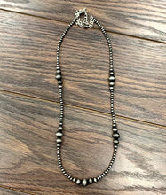 Load image into Gallery viewer, Beaded necklace on a wooden surface
