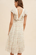 Load image into Gallery viewer, Woman wearing a floral dress with ruffled sleeves on a beige background