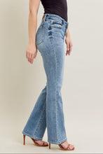 Load image into Gallery viewer, Woman wearing blue jeans and a black top on a plain background
