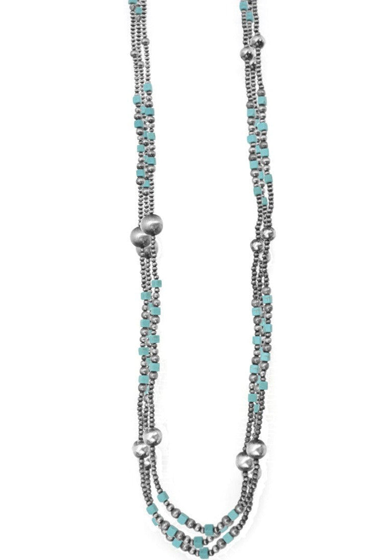 A long necklace featuring a pattern of blue gemstone beads and silver-colored metal beads, with a silver-tone infinity symbol at the center.