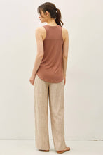 Load image into Gallery viewer, Woman wearing a brown sleeveless top and beige pants on a white background
