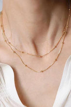 Load image into Gallery viewer, Gold necklace on a person wearing a white top