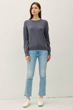 Load image into Gallery viewer, Woman wearing a dark gray sweater and light blue jeans on a white background