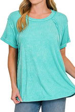 Load image into Gallery viewer, Woman wearing a turquoise t-shirt on a white background