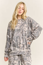 Load image into Gallery viewer, Woman wearing a camouflage outfit on a beige background