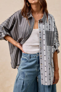 Woman wearing a plaid shirt over a white top and blue jeans on a beige background
