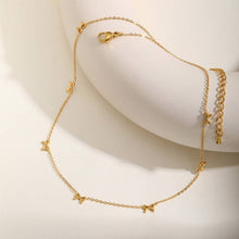 Load image into Gallery viewer, Gold necklace with star-shaped charms on a white background