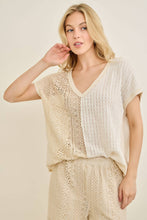 Load image into Gallery viewer, Woman wearing a beige and white outfit with a textured pattern on a plain background