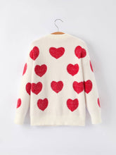 Load image into Gallery viewer, Cream-colored sweater with red heart patterns on a white background