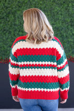 Load image into Gallery viewer, Woman wearing red green and white christmas sweater with a green ivy background