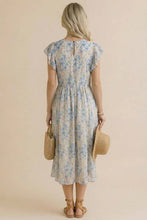 Load image into Gallery viewer, Woman wearing a floral dress holding two woven bags against a beige background