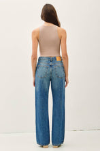 Load image into Gallery viewer, Woman wearing a beige tank top and blue jeans on a white background