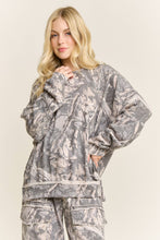 Load image into Gallery viewer, Woman wearing a gray floral patterned outfit on a beige background