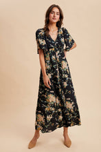 Load image into Gallery viewer, Woman wearing a floral dress on a beige background