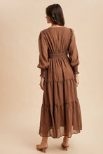 Load image into Gallery viewer, Woman wearing a brown patterned dress on a beige background