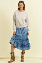 Load image into Gallery viewer, Woman wearing a beige sweater, blue denim skirt, and cowboy boots on a beige background