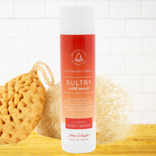Load image into Gallery viewer, Body wash bottle labeled &#39;Sultry Wild Musk&#39; with sponges on a white background